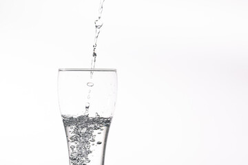 Pouring water into a glass on a white background. Close-up image,Glass of drinking water isolated on white background 