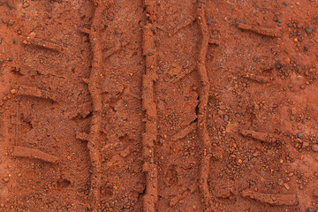 Close-up of car tire pattern on the ground,Close up of tire track or tire tread left behind in the mud or dirt.