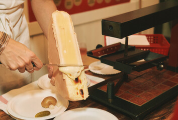 Old ancient way to cook raclette, traditional swiss cheese plate
