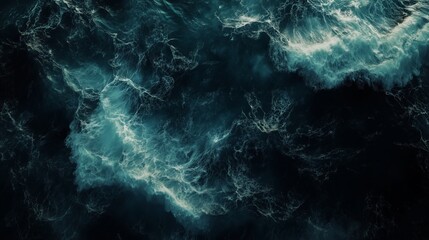 Top-down view of ocean with a dark teal and black color waves.