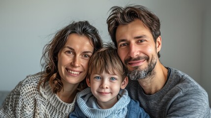 Fototapeta premium Happy Family Portrait - Mother, Father, and Son Smiling Together.