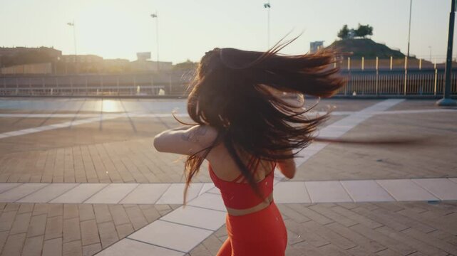Young woman training in kung fu wushu martial arts outdoor with weapons and swords.
