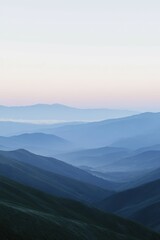 Fototapeta premium Morning mist envelops the rolling hills at dawn in tranquil mountains
