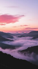 Obraz premium Serene sunrise over misty mountains at dawn in a tranquil landscape