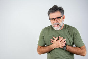 Senior man is having pain in his chest. Heart attack symptoms. Mature man holding his heart in...