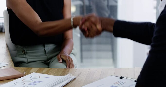 Closeup, business people and handshake with partnership, meeting and documents with cooperation. Negotiation, manager or employee with paperwork, b2b deal and contract with collaboration and teamwork