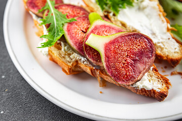 sandwich fig croissant, cream cheese fresh meal food snack on the table copy space food background rustic top view vegetarian vegan food
