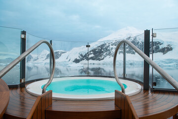 Outdoor hot tub against snow mountain landscape in Antarctica.