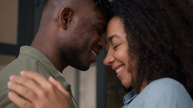 Married couple happy ethnic family African American woman man bonding touch forehead cuddle girlfriend boyfriend male female faces close up husband wife affection lovers romantic anniversary wedding