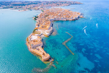 Aerial of Ortigia island, old town with turquoise sea of Syracuse. Small island on Sicily, Italy.