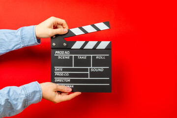 Movie clapper. Movie clapper in hands on bright colored background. Concept of rest and...