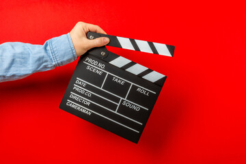 Movie clapper. Movie clapper in hands on bright colored background. Concept of rest and...