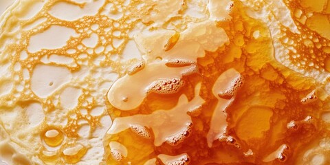Pancake drizzled with honey close up.