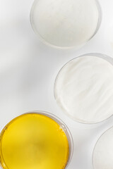 Antiaging cosmetic products in Petri dishes in white table