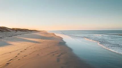 Gardinen Serene Morning on Saint-Jean-de-Monts Beach in France, with the Sun Rising Over the Horizon and Casting a Soft Light on the Calm Sea © Monty