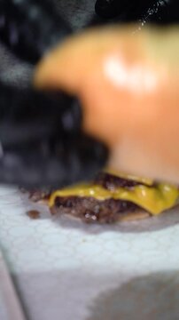 chef preparing a tripple cheese burger