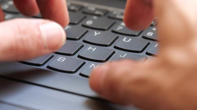 Man typing fast on a new gray modern laptop keyboard, closeup, real time, one person. Creative content writing, quickly typing something on a keyboard. Blogging, programming simple abstract concept