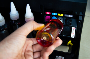Image of refilling ink, printer, refillable printer