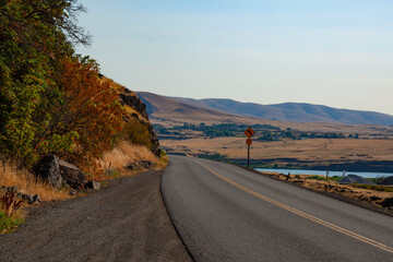 A winding road meanders through Pendleton, Oregon, tracing the contours of its rolling hills and offering stunning, scenic views of the picturesque landscape.