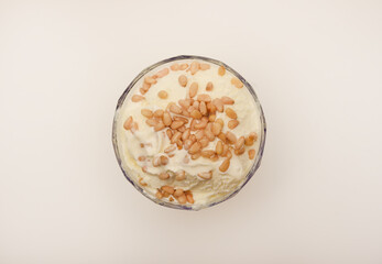 Ice cream in a glass ice cream maker with pine nuts. Ice cream with nuts.