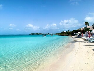Turks and Caicos beaches feature soft, white sand blending seamlessly into crystal-clear turquoise waters. The gentle waves and endless horizon create a serene and picturesque tropical escape.