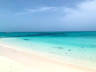 Turks and Caicos beaches feature soft, white sand blending seamlessly into crystal-clear turquoise waters. The gentle waves and endless horizon create a serene and picturesque tropical escape.