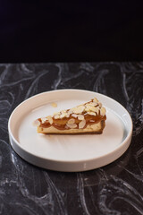 A Deliciously Crafted Slice of Almond Cake with a Beautiful Mango Glaze on an Elegant Plate