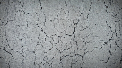 High-resolution cracked earth texture featuring natural gray tones. Perfect for 4K backgrounds, wallpapers, banners, and nature-themed design backdrops, capturing the rugged beauty of dried soil