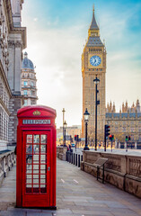 Red telephone box on Parliament square and Big Ben tower, London, UK