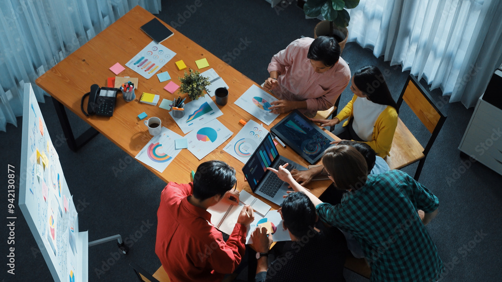 Poster top down view of business team putting hand together while discussing about ux ui design for mobile 