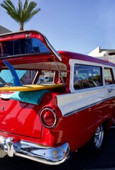 vintage car with surfboard at the beach