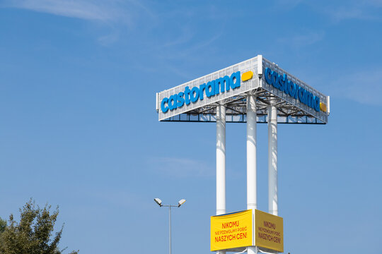 Warsaw, Poland - August 24, 2024: Castorama retail store sign mounted on tall white pillars against a clear blue sky