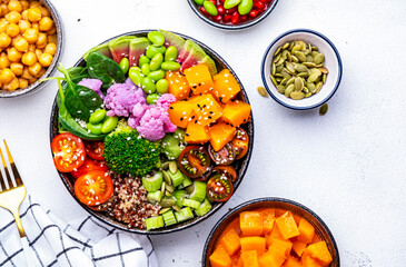 Vegan buddha bowl for balanced diet with sweet potato, quinoa, tomatoes, spinach, celery, edamame, tofu, broccoli and seeds, white background, top view