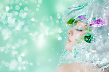 A woman with a green and purple flowery headdress. The woman has a very pretty face and is wearing a lot of makeup