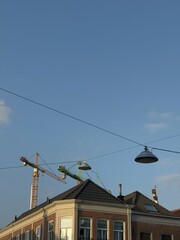 construction cranes against the backdrop of old houses