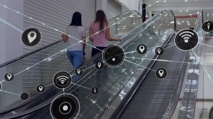 Network connectivity icons animation over people on escalator in shopping mall - Powered by Adobe