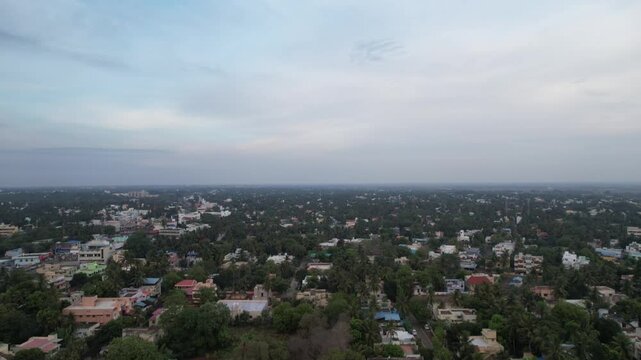 Aerial video town landscape. Tanjore's outer town's hospitals, government buildings, marriage hall, school, and main road are visible in early morning aerial footage.