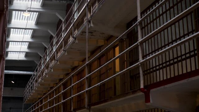 Slow motion landscape inside prison cell block jail gaol crime penitentiary bars railings Alcatraz Island San Francisco city California USA America travel tourism attraction landmark