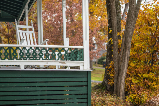 USA, Maine, Bayside. Bayview Cottages, oceanside community at a former religious themed resort porch during autumn.