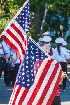 USA, Massachusetts, Cape Ann, Rockport. Fourth of July parade, young girl with US flag.