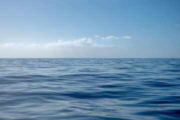 Tranquil landscape scene with ocean horizon and calm cloudscape