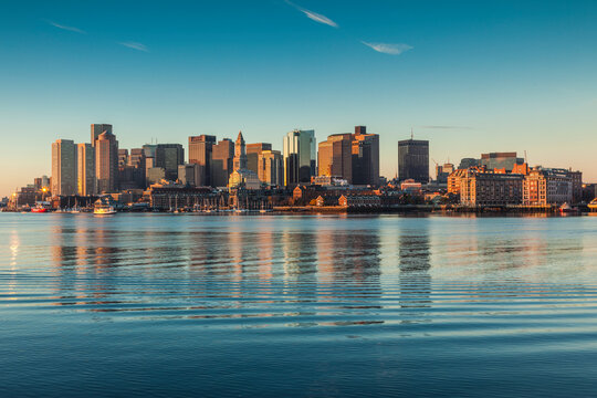 USA, Massachusetts, Boston. City skyline from Boston Harbor at dawn.