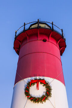 USA, Massachusetts, Cape Cod, Eastham. Nauset Light with Christmas wreath at dawn.