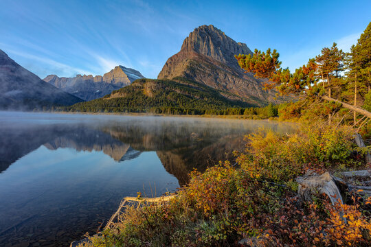 Grinnell Point and Mt. Gould reflection into Swiftcurrent Lake in early autumn in Glacier National Park, Montana, USA