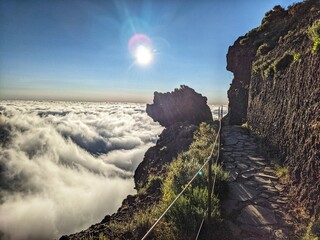 Majestic mountain peaks in Madeira, Portugal, rising above a sea of clouds