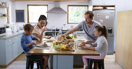 Food, breakfast and funny with family in kitchen for health, love and eating together. Smile, lunch and nutrition with parents and children at dining table in home for happy, wellness and bonding