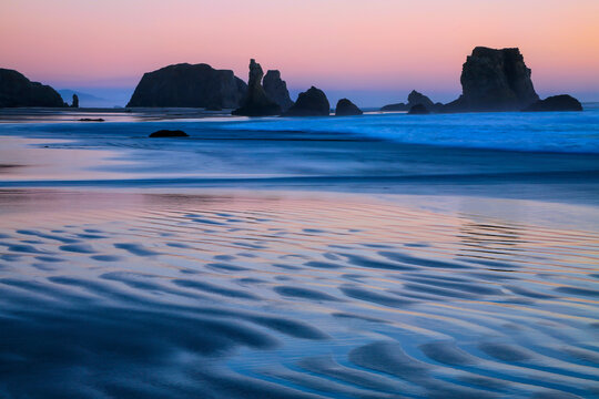 USA, Oregon, Bandon. Sunset on beach sea stacks. 