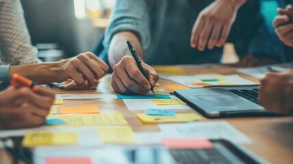 Fototapeta premium A consulting team brainstorming new business solutions on sticky notes during a creative workshop