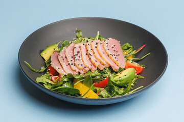 Appetizing salad with duck breast. Food photography, restaurant food presentation.