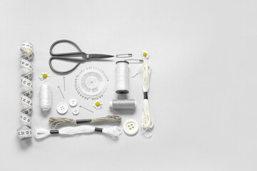 Fototapeta premium Set of different embroidery supplies on grey background